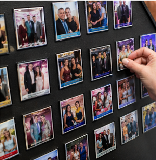Custom photo magnets displayed on a board at an event